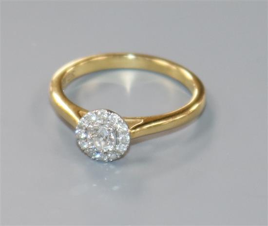 A modern 18ct gold and diamond cluster ring, size M.
